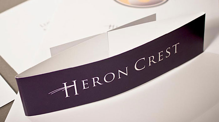 Close-up photo of the belly band used to enclose the Heron Crest brochure system