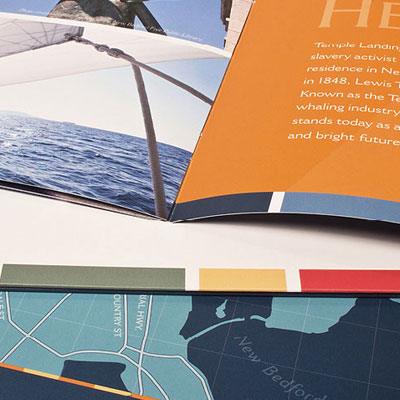 Close-up detail photo of the Temple Landing brochure showing part of a spread and front and back covers